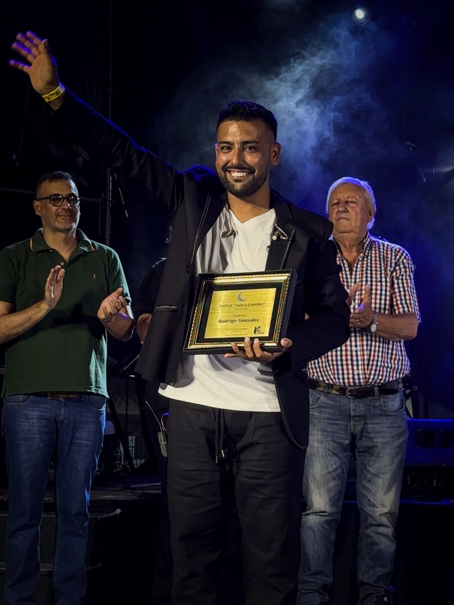Rodrigo González recibiendo un reconocimiento en el escenario